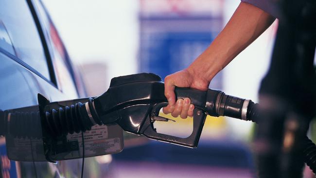 Man pumping fuel into his car.