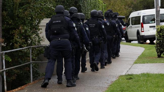 Police descended on the waterfront suburb on Thursday evening. Picture: Jonathan Ng