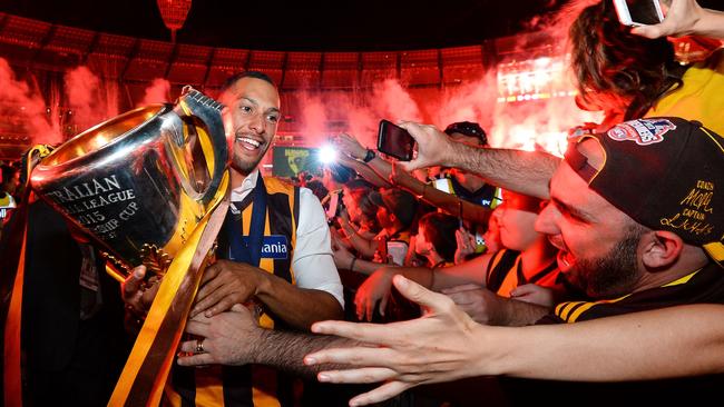 Josh Gibson shows off the premiership cup to Hawks fans.