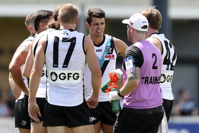 Power’s Ryan Burton stands with his other defenders after North kick the first goal within the first few seconds of the game at Alberton Oval. Picture Sarah Reed