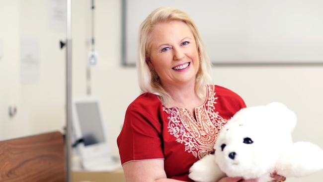 Researcher Professor Wendy Moyle and a robotic seal, Paro, which assists dementia patients.