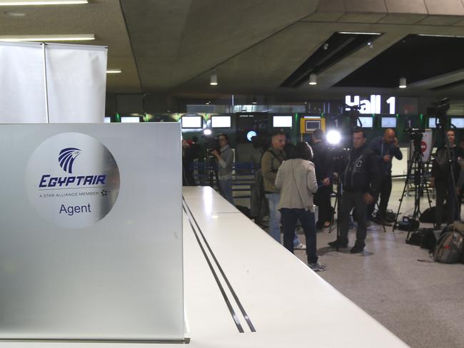 Reporters gather in front of the EgyptAir counter at Paris airport.