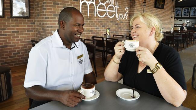 Coffee Club franchisees Boubacar Barry and Angela Holmes-Barry in their Brookwater Village Coffee Club. Picture: Claudia Baxter