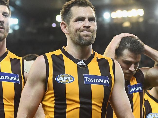 MELBOURNE, AUSTRALIA - SEPTEMBER 16: Jack Fitzpatrick, Luke Hodge and Isaac Smith of the Hawks look dejected after losing the second AFL semi final between Hawthorn Hawks and Western Bulldogs at Melbourne Cricket Ground on September 16, 2016 in Melbourne, Australia. (Photo by Quinn Rooney/Getty Images)