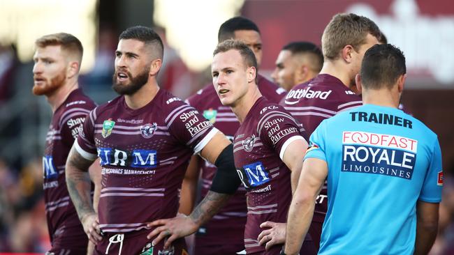 Daly Cherry-Evans of the Sea Eagles and team mates look dejected after another Roosters try