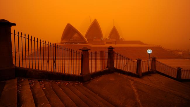 In 2009, the Opera House looked like it had landed on Mars as red dust from Central Australia was carried by high winds, causing chaos. Picture: James D. Morgan/Getty Images