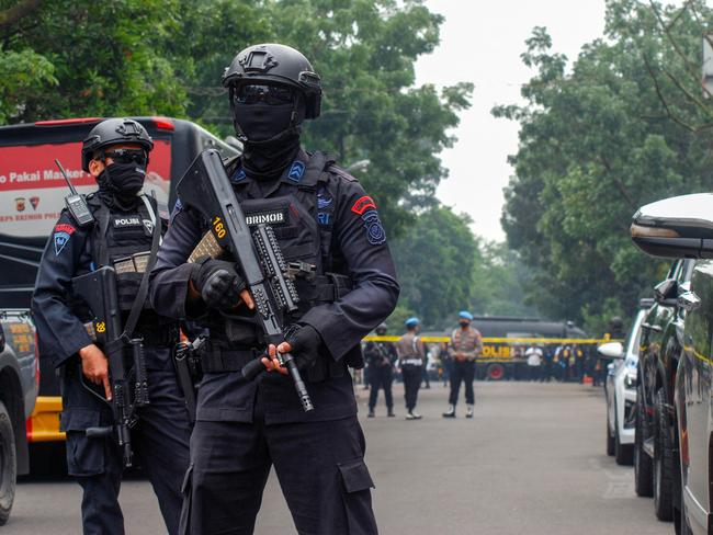 Officers outside the police station where the suicide attack took place. Picture: AFP