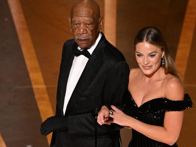 US actor Morgan Freeman (L) and Australian actress Margot Robbie speak onstage during the 95th Annual Academy Awards at the Dolby Theatre in Hollywood, California on March 12, 2023. (Photo by Patrick T. Fallon / AFP)