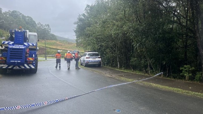 The man was trapped inside the crane after it rolled down a steep embankment towards Currumbin Creek. Picture: 9 News