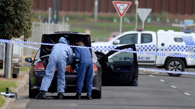 Police inspect a car on Golsworthy Rd Corio believed to have been linked to the early morning shooting death. Picture: Andrew Henshaw