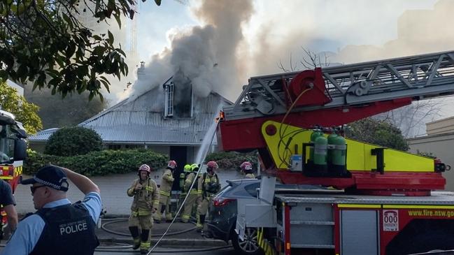 A cherry picker had to be brought in to battle the blaze in the historic weatherboard house. Picture: TNV