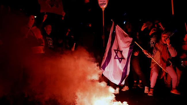 Protesters use a smoke torch during a demonstration calling for a hostages deal and against the Israeli government. Picture: Getty Images