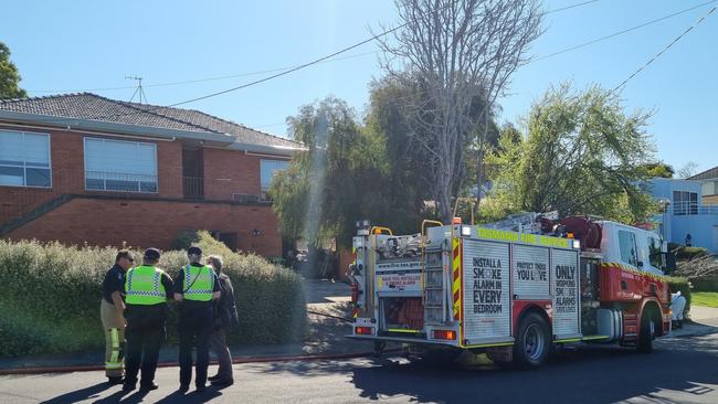 Emergency services outside a home in Moonah where a light bulb caused a fire. Picture: Kenji Sato.