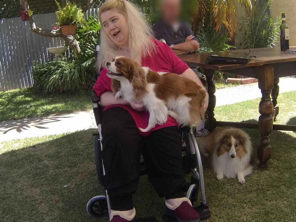 Ann Marie Smith happy at a social occasion in 2011 , with her dogs Maggie and Deana. Picture: SAPOL