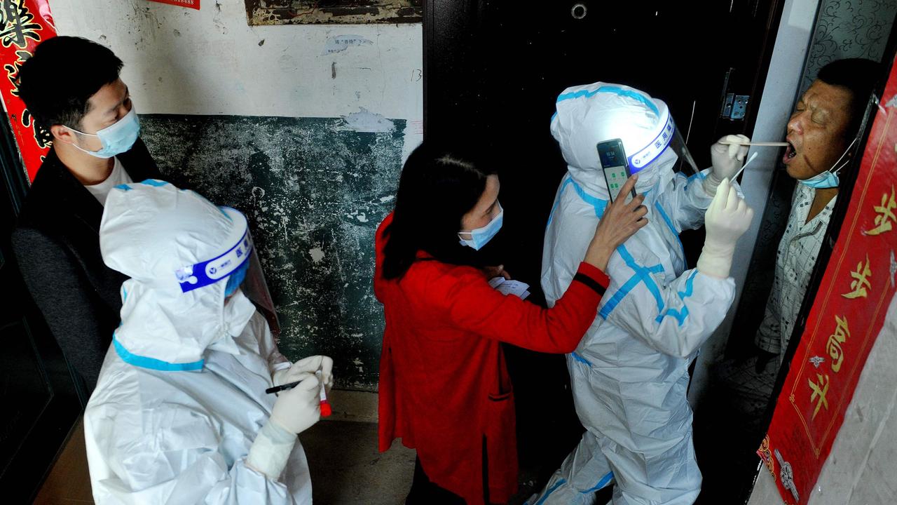 Officials and medical workers conduct a Covid-19 coronavirus test on a resident isolating at home following the recent coronavirus outbreak in Dexing, in China's central Jiangxi province, on November 3, 2021. Picture: AFP / China OUT.