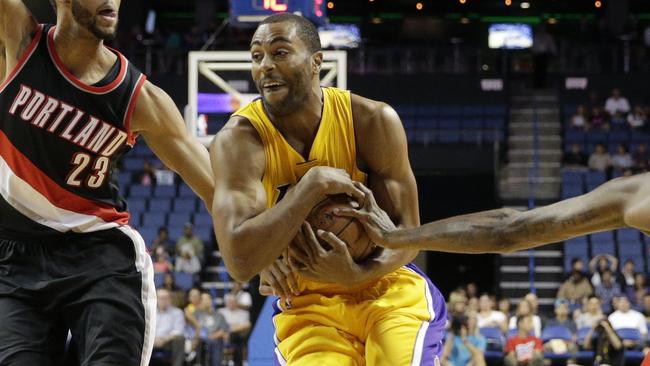 Los Angeles Lakers' Wayne Ellington, center, drives between Portland Trail Blazers' Allen Crabbe, left, and Dorell Wright during the first half of a preseason NBA basketball game Wednesday, Oct. 22, 2014, in Ontario, Calif. (AP Photo/Jae C. Hong)