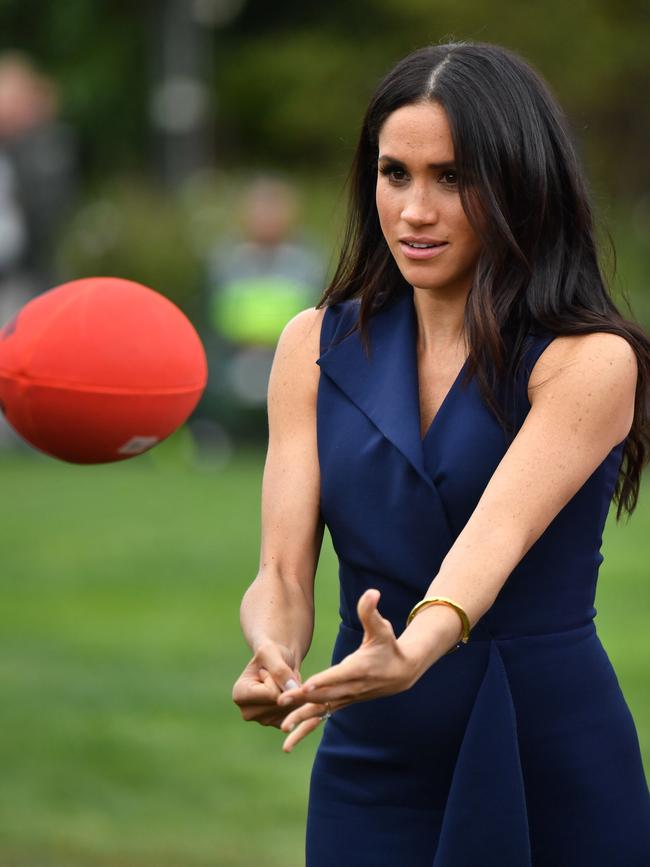 The Duchess of Sussex shows off her handballing skills. Picture: AP