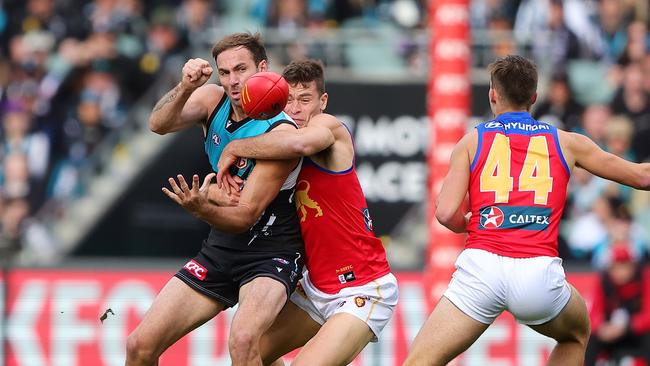 ADELAIDE, AUSTRALIA - JUNE 22: Jeremy Finlayson of the Power and Josh Dunkley of the Lions during the 2024 AFL Round 15 match between the Port Adelaide Power and the Brisbane Lions at Adelaide Oval on June 22, 2024 in Adelaide, Australia. (Photo by Sarah Reed/AFL Photos via Getty Images)