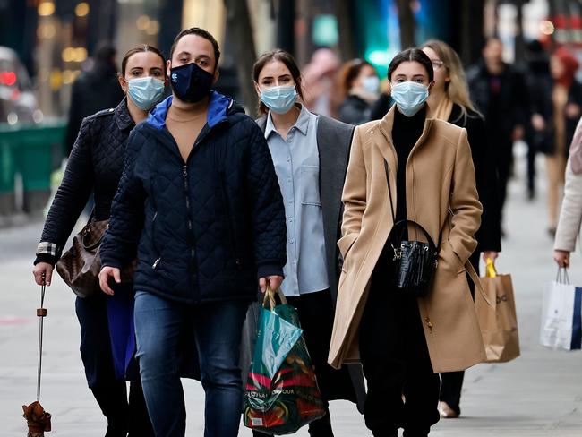 Pedestrians wearing a face mask or covering due to the COVID-19 pandemic, walk along Oxford Street in central London on December 22, 2020. - UK government borrowing continued to soar in November on emergency action to support the virus-hit economy which nevertheless rebounded stronger than expected in the third quarter, official data showed Tuesday. Government borrowing last month hit Â£31.6 billion ($41.8 billion, 34.2 billion euros), a record for November -- taking public sector net debt to Â£2.1 trillion, the Office for National Statistics said in a statement. (Photo by Tolga Akmen / AFP)