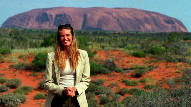 Elle poses at Uluru for the launch of her haircare products, adding another strand to her empire. Picture: Mark Williams