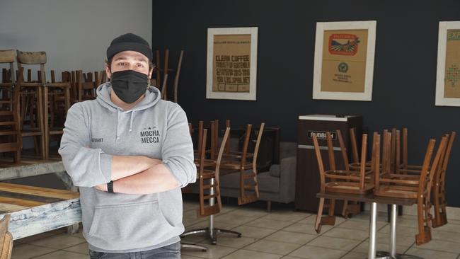 Mocha Mecca Mildura City owner Stuart Garsed stands in a customer-free indoor dining area of his cafe.