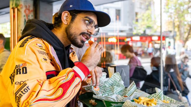 Itish Vinayak tucks into a meal at Wingstop's Australian Launch in Potts Point.Picture: NewsWire / Monique Harmer