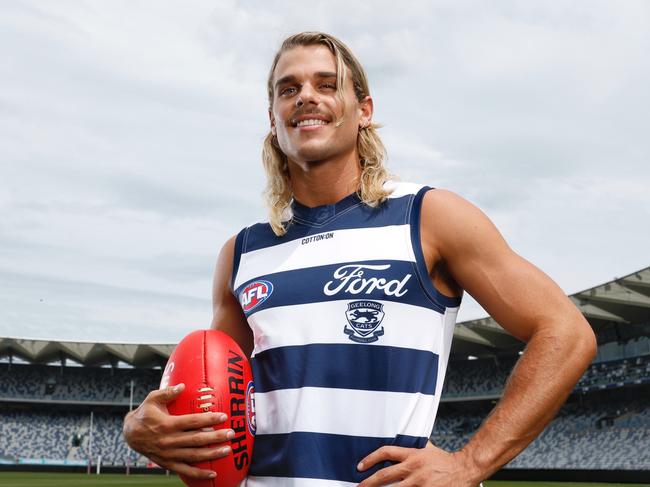 AFL star Bailey Smith proudly dons his new Geelong Cats jersey at GMHBA Stadium after being traded from the Western Bulldogs on Wednesday night. Picture: Michael Klein.