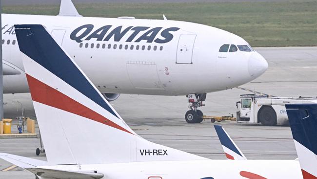 Rex Airlines Boeing 737 planes lay idle on the tarmac at Melbourne's Tullamarine Airport on July 31, 2024. The Australian regional airline Rex cancelled flights as it entered voluntary administration on July 31, leaving the fate of the country's third-largest carrier in serious doubt. (Photo by William WEST / AFP)