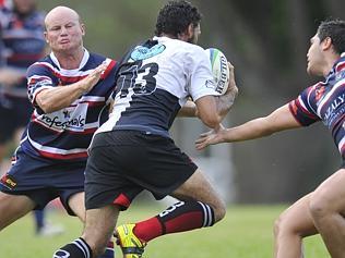 Palmerston’s Tom Hurst takes on University’s Anthony Heal. Picture: HELEN ORR