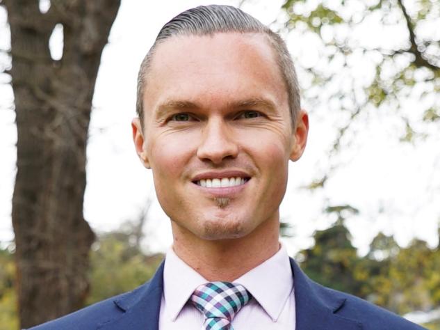 Deputy Mayor of Moonee Valley, Cam Nation, proudly waves the rainbow flag after council's recent endorsement of marriage equality in Australia.