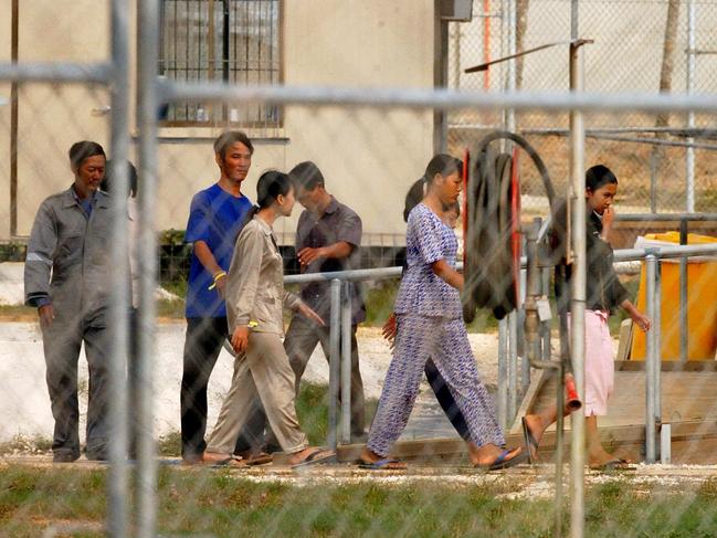 Christmas Island, July 6, 2003. Some of the 53 Vietnamese asylum seekers at the Christmas Island detention centre today. The asylum seekers were picked up from Port Hedland off the Western Australian coast by HMAS Canberra last Tuesday. (AAP Image/Mick Tsikas) NO ARCHIVING