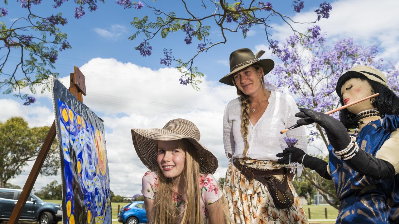 Goombungee residents Ava Schultz and mum Jade Schultz check out the display by the Rosalie Gallery and Goombungee Library for Jacaranda Day in Goombungee, Saturday, November 6, 2021. Picture: Kevin Farmer