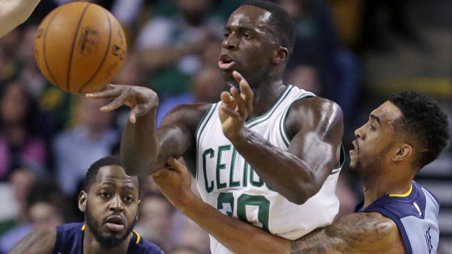 Boston Celtics forward Brandon Bass passes the ball under pressure.