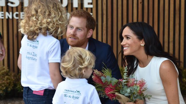 Prince Harry and Meghan speak to six-year-old Dasha Gallagher and four-year-old Findlay Blue at Taronga Zoo. Picture: Peter Parks/AFP