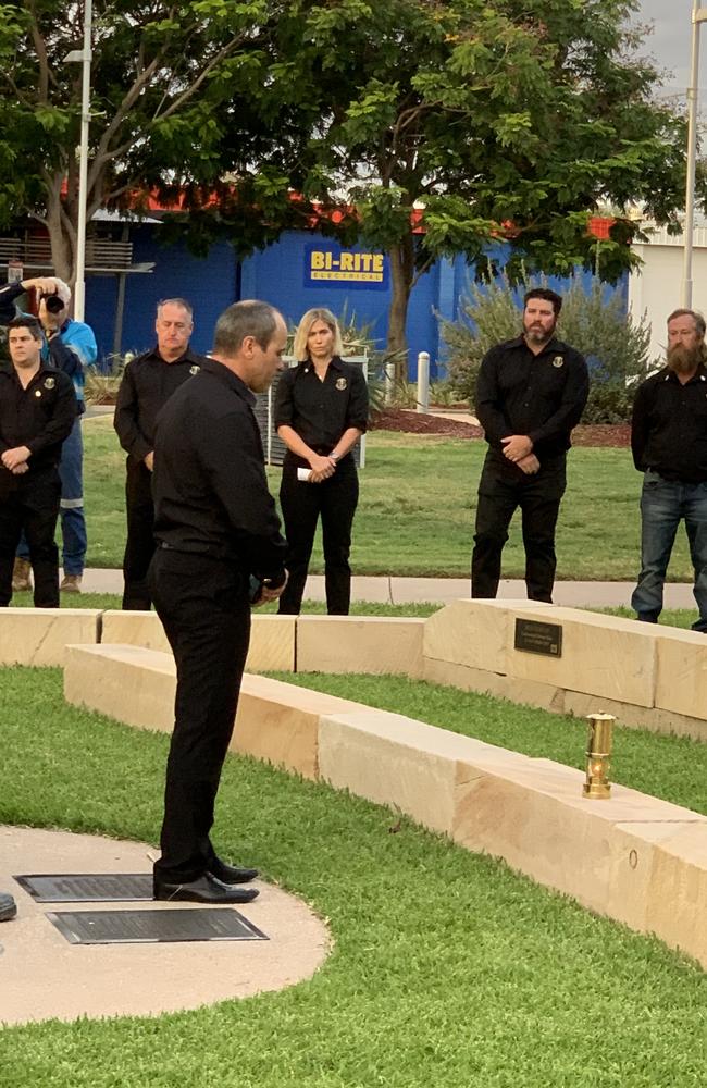 Moranbah Miners' Memorial secretary Andy Collins leaves a lit lamp in honour of Moranbah North miner Gavin Feltwell. Picture: Duncan Evans