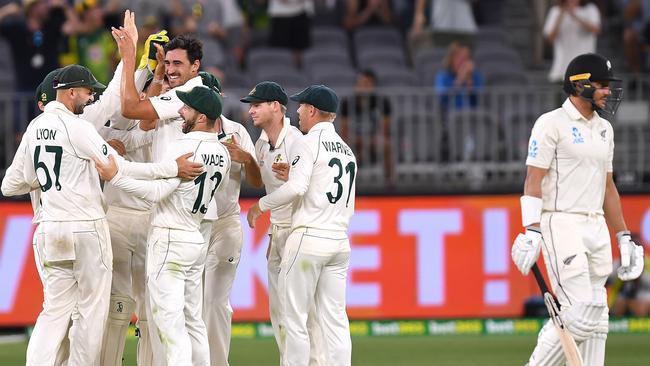 Australian paceman Mitchell Starc picks up the wicket of Neil Wagner first ball. Picture: AAP