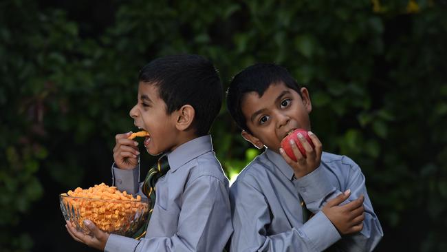 Ravi, 6 and Rahul, 8, test out some twisties and an apple. Picture: David Smith