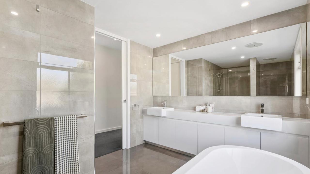 Spa retreat inspired finishes and elegant fixtures add a touch of hotel-style luxury to the home’s wet areas.