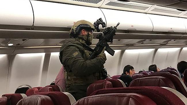 Heavily armed police board a Malaysia Airlines flight in Melbourne after an attempted hijacking incident. Picture: AFP/Andrew Leoncelli