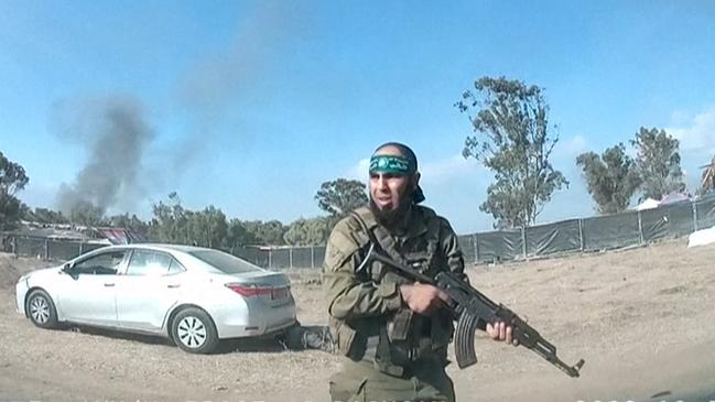 An Armed Palestinian militant walking around the music festival, near Kibbutz Reim in the Negev desert in southern Israel. Picture: AFP