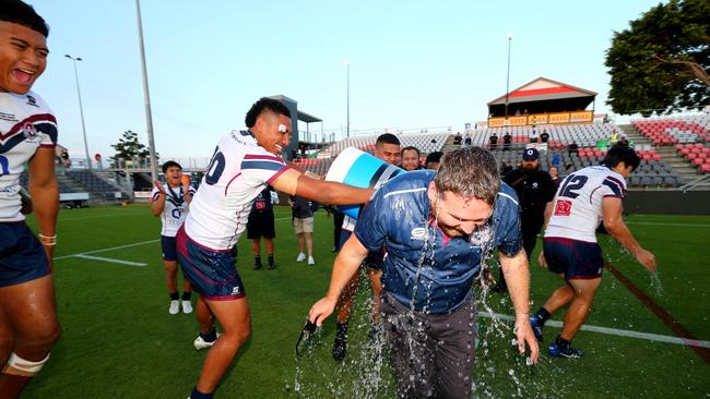 Ipswich coach Josh Bretherton taking a bath after his team took out the National Schoolboys Cup against Patrician Brothers Fairfield last year.