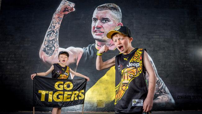 Young tigers fans Nelson and Fred visit the Dustin Martin mural that was painted overnight after his Brownlow Medal win in 2017. Picture: Jake Nowakowski