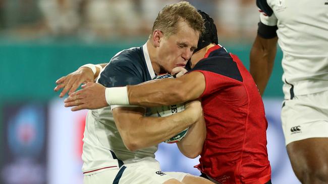 Will Hooley of the USA is tackled by Piers Francis in the first minute.