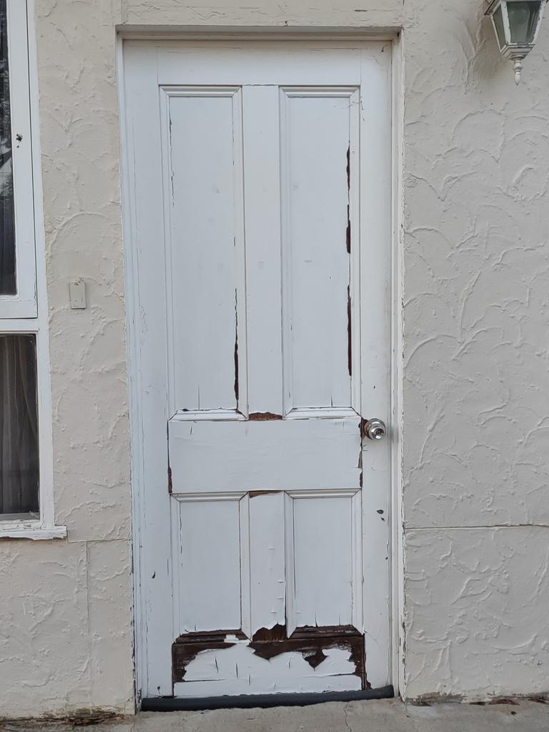 A waterlogged and rotting door one Adelaide renter has to put up with because the landlord won't fix the problem. Picture: Supplied by tenant