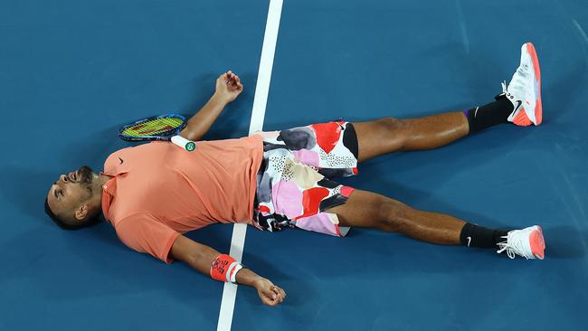 Nick Kyrgios lays on the court after losing a point against Rafael Nadal