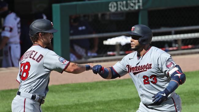 CHICAGO, ILLINOIS - JULY 26: Nelson Cruz #23 of the Minnesota Twins is congratulated by Aaron Whitefield #58 after hitting a three run home run in the 8th inning against the Chicago White Sox at Guaranteed Rate Field on July 26, 2020 in Chicago, Illinois. (Photo by Jonathan Daniel/Getty Images)