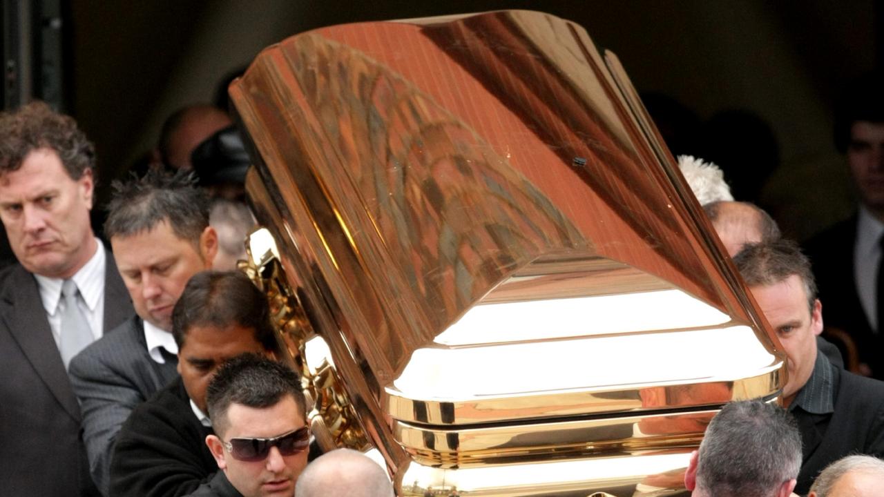 The gold coffin with the body of gangland killer Carl Williams leaves the funeral service at a church in Essendon. Picture: Stuart Mcevoy 