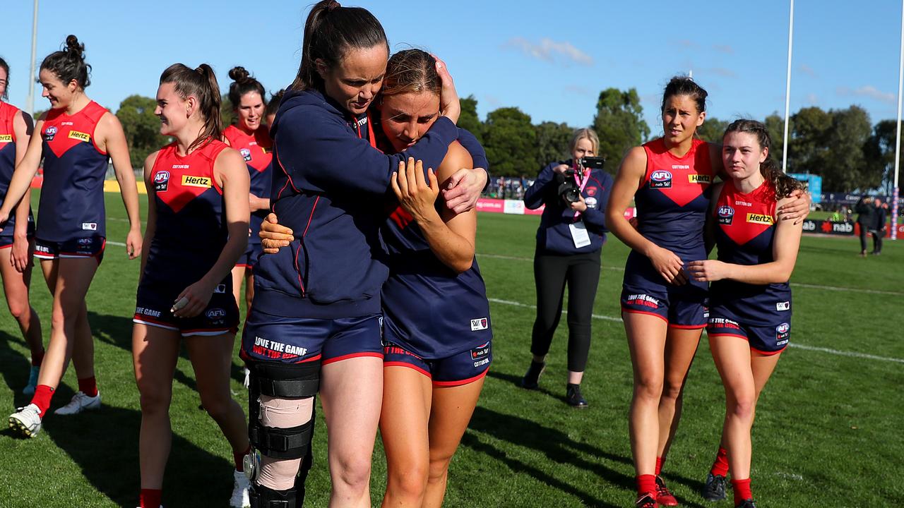 Daisy Pearce with her leg in a brace and teammate Eliza McNamara after beating the Brisbane Lions. Picture: Getty Images