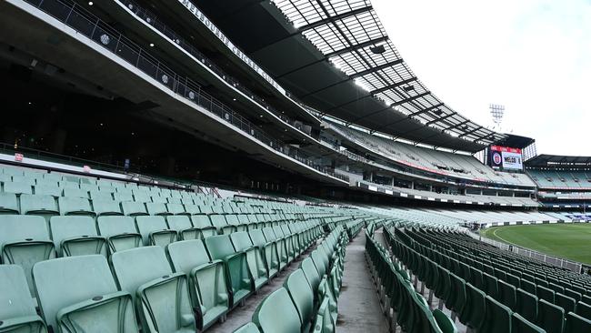 Sign of the times: Empty seats at the MCG during the Round 18 match between Collingwood and Carlton.