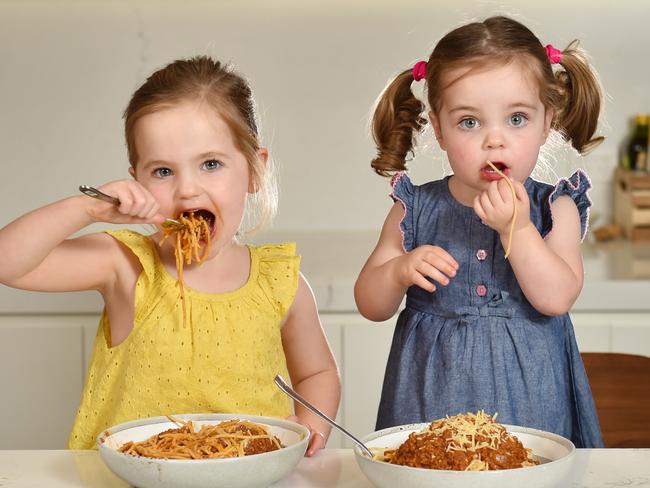 **ATTN ANDRE GRIMAUX**Pic of sisters Ruby Aldcroft, 4 and Evie, 2, eating spaghetti bolognese. Coles have Dropped and Locked the price of beef and big brands to help families prepare for the cooler months. Picture : Nicki Connolly